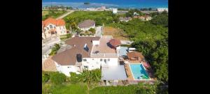 an aerial view of a house with a swimming pool at Hills Royale Villa -Ironshore Montego Bay in Montego Bay