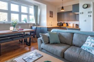 a living room with a couch and a table at Flat 3, Abbey House in Binham