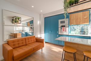 a living room with a couch and a kitchen at Amazing Setúbal in Setúbal