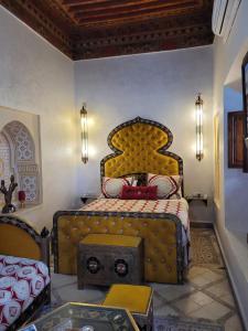 Riad Bayti في مراكش: غرفة نوم بسرير مع اللوح الأمامي الأصفر