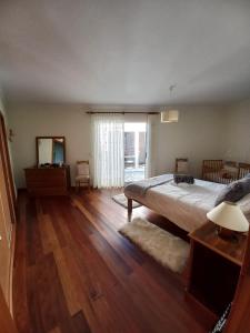 a bedroom with a large bed and a mirror at Casa Abreu Gouveia in Ponta do Pargo in Calheta