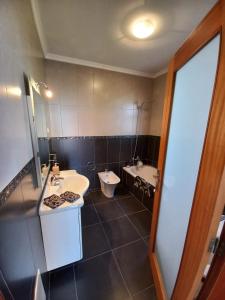 a bathroom with a sink and a toilet in it at Casa Abreu Gouveia in Ponta do Pargo in Calheta