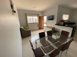 a dining room and kitchen with a glass table and chairs at Casa em barreirinhas in Barreirinhas