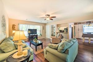 a living room with two couches and a television at Oak Island Home with Fenced Yard, Walk to Long Beach in Oak Island