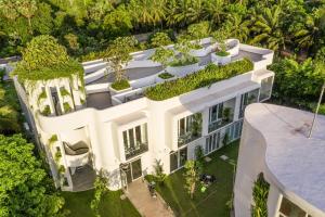 an aerial view of a white building with plants at Enjoy boutique in Siem Reap