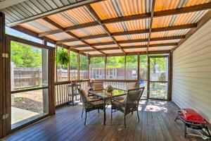 a screened in porch with a table and chairs at Oak Island Home with Fenced Yard, Walk to Long Beach in Oak Island