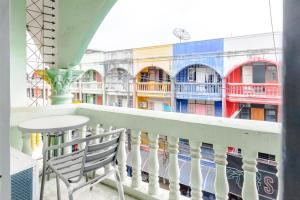a balcony with a table and a view of a building at High5 Guesthouse in Pattaya Central