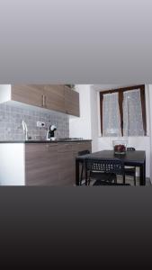 a kitchen with a table and a black table and chairs at Meghan Home in Catania