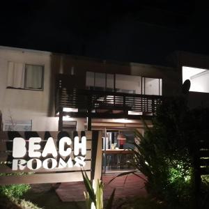 a house with a beach rooms sign in front of it at Balconada Beach ROOMS in La Paloma