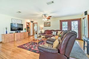 a living room with a couch and a tv at Pet-Friendly Austin Home with Private Hot Tub! in Austin
