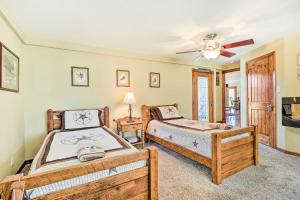 a bedroom with two beds and a ceiling fan at Pet-Friendly Austin Home with Private Hot Tub! in Austin