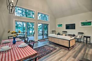 a living room with a couch and a table at Modern Francestown Retreat on Scobie Pond! in Francestown