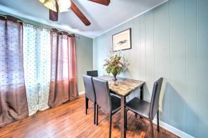 a dining room table with chairs and a vase of flowers on it at Eastlake Vacation Rental Near Lake Erie! in Eastlake