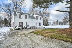 a white house with snow on the ground at Eastlake Vacation Rental Near Lake Erie! in Eastlake