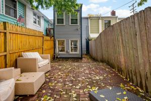 a patio with two chairs and a fence at Boutique Blue 2 bedroom Old Town House in Alexandria