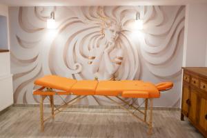 an orange bench in a room with a wall at Monti Chalet in Poiana Brasov