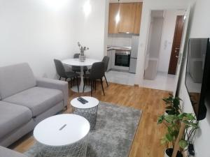 a living room with a couch and a table at Sofija City BL in Banja Luka
