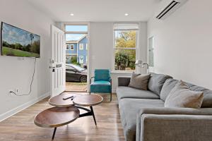 a living room with a couch and two tables at Boutique Blue 2 bedroom Old Town House in Alexandria