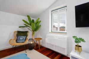 a living room with a radiator and a chair and a window at Setubal Downtown N97, By Home Match in Setúbal