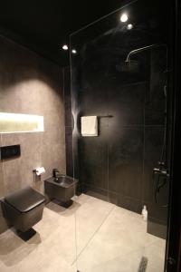 a bathroom with a shower and a toilet and a sink at King’s Apartment in Korçë