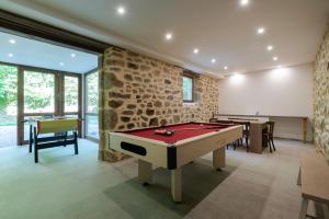a gaming room with a pool table and two tables at Gites de La Soulière in Aubin