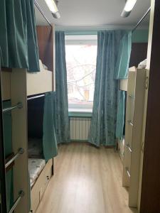 a room with a window and a room with bunk beds at Golden Square in Almaty +9 photos