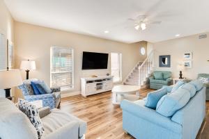 a living room with blue furniture and a flat screen tv at Beach Haven by Meyer Vacation Rentals in Gulf Shores