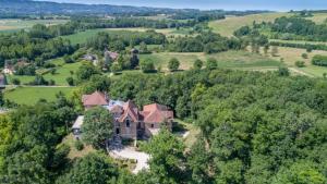 an aerial view of a large house in the trees at La Garenne de Morestel in Morestel