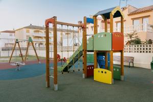 a playground with a slide and a play structure at A Casa Martinez Playa Sin Ascensor in Mareny Barraquetas