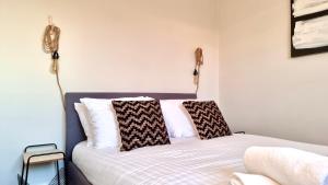a bedroom with a bed with two pillows on it at The Loft by Switchback Stays in Cardiff