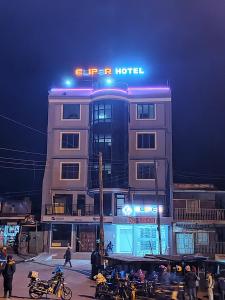 a hotel with motorcycles parked in front of it at night at Eliper Hotel 