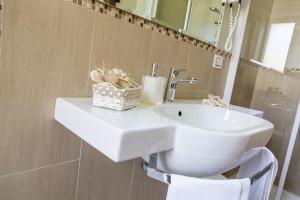 y baño con lavabo blanco y espejo. en Hotel Vittoria, en Vasto