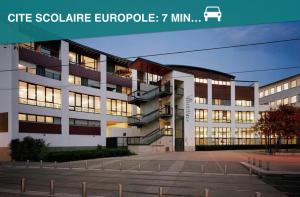 a building with lights on in a parking lot at Guest-K Peretto Netfix-Balcon-Free Parking in Grenoble