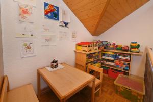 a dining room with a table and a book shelf at Mühlenhof in Eichenberg