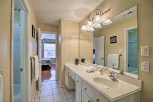 a bathroom with a sink and a large mirror at 2,500 Sq Ft Townhome - Walk to Central River Oaks! in Houston +29 photos
