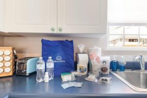 a kitchen counter with a bag of water and groceries at The Hairy Crab in Oak Island