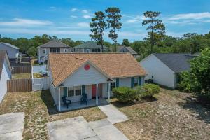 a view of a house with a yard at The Hairy Crab in Oak Island