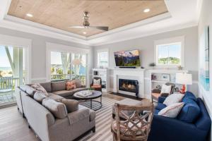 a living room with a couch and a fireplace at Naut A Bad Gig in Oak Island