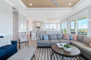 a living room with a couch and a table at Naut A Bad Gig in Oak Island