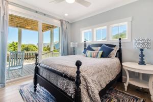 a bedroom with a bed and a balcony at Naut A Bad Gig in Oak Island +42 photos