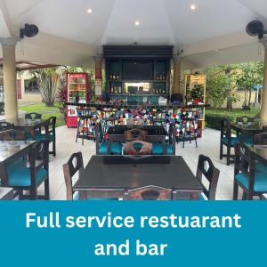 a restaurant with a full service restaurant and bar at Las Brisas Resort and Villas in Jacó