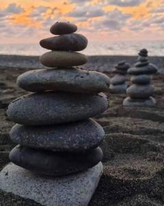 a stack of rocks sitting on a beach at La Luna Elyu 