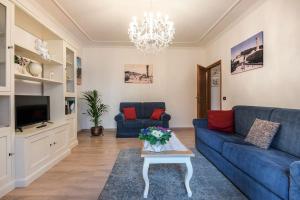 a living room with a blue couch and a table at Fiesole is Magic in Fiesole