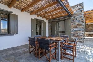 a dining room with a wooden table and chairs at Breathtaking View Villa - Otzias in Korissia