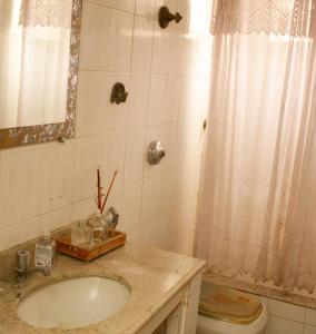 a bathroom with a sink and a toilet at Apartamento Gutierrez 1 in Belo Horizonte
