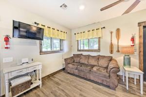 a living room with a couch and a flat screen tv at Waterfront Nevada Escape with Private Pond and Dock! in Nevada