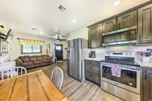 a kitchen with stainless steel appliances and a wooden table at Waterfront Nevada Escape with Private Pond and Dock! in Nevada