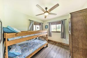 a bedroom with two bunk beds and a ceiling fan at Waterfront Nevada Escape with Private Pond and Dock! in Nevada