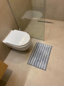 a bathroom with a toilet and a glass shower at Bakuriani Kokhta Mitarbi Resort in Bakuriani +19 photos