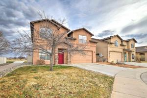 a large brick house with a red door at Stocked Grand Junction Home at Canyon View Park! in Grand Junction